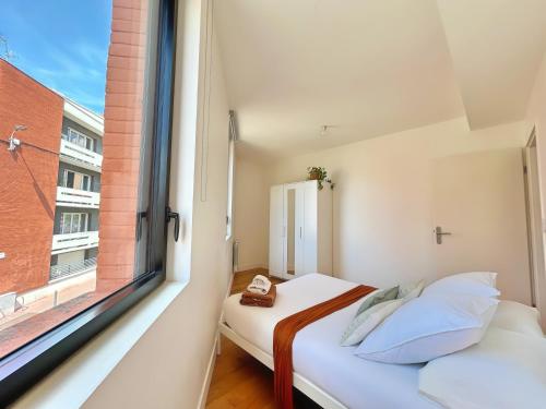 Cama o camas de una habitación en La Chocolatine - Climatiseur - 2 chambres - Wifi - Proche gare