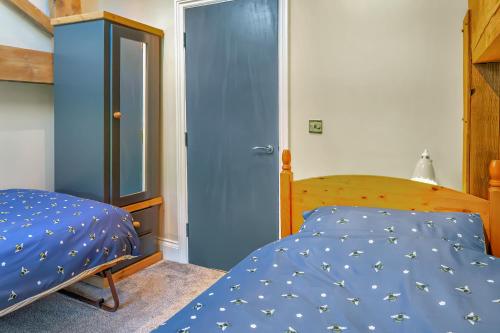 a bedroom with a bed and a blue door at Luxury Escape with Cinema, Pool Table & Darts in Leeds