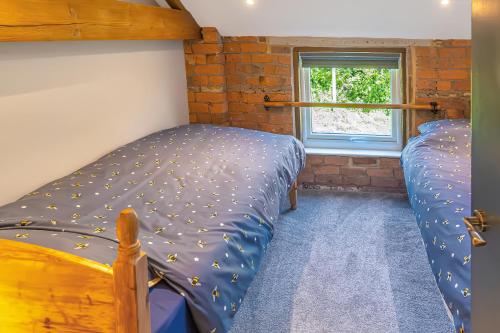 a bedroom with two bunk beds and a window at Luxury Escape with Cinema, Pool Table & Darts in Leeds