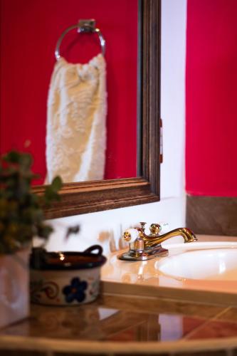 a bathroom sink with a mirror and a wedding dress at SOLACHE INN in Zitácuaro