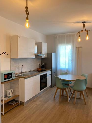 Una cocina y un comedor con mesa y sillas. en A mare Chioggia, en Chioggia
