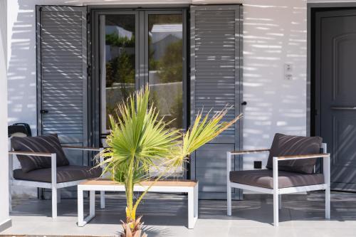 a group of chairs and a table on a porch at Filia Skyros Suites in Skiros