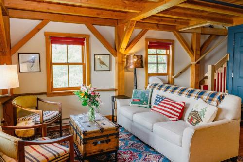 a living room with a couch and a table at The Inn at Stonecliffe in Mackinac Island