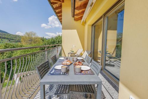 a table with plates of food on a balcony at Lake & Whispers - Among Lake Como and Switzerland in San Fedele Intelvi
