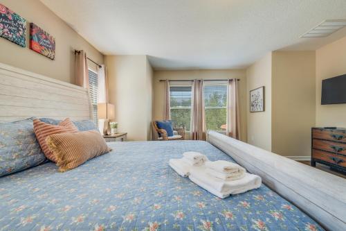 a bedroom with a large bed with towels on it at The Hearth Home - 4 Suites in Kissimmee