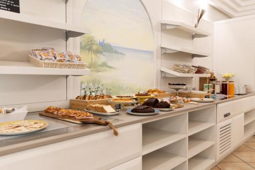 a buffet line with pastries and other food at Hotel La Nidiola in Riccione