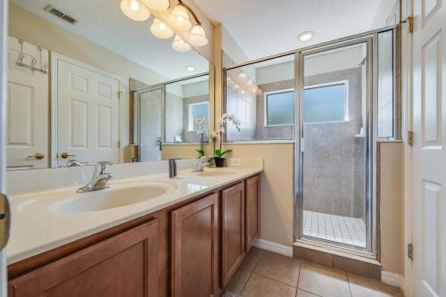 a bathroom with a large sink and a shower at The Hearth Home - 4 Suites in Kissimmee