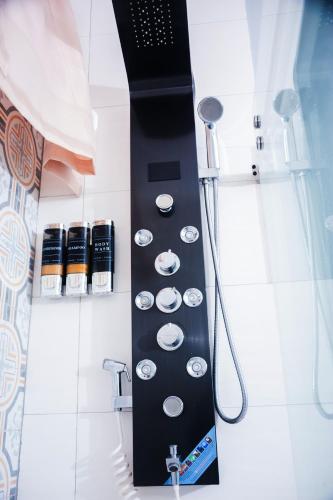 a shower in a bathroom with a black wall at Serene Mountain View Smart Apt for Restful Stays in Castries