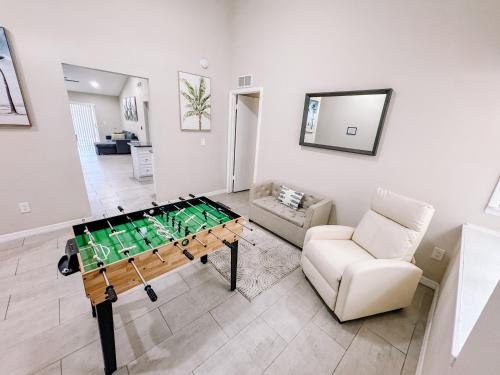 a living room with a ping pong table and a couch at Stylish Urban Haven, Cozy, Central in Lutz