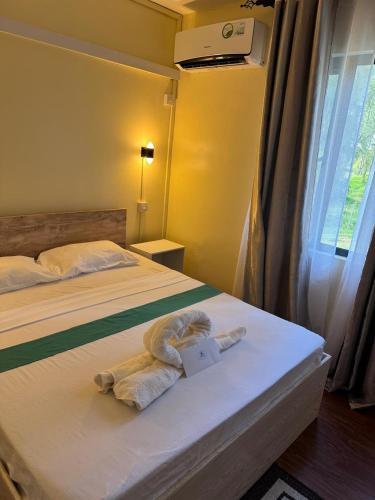 a hotel room with a bed with a towel on it at Gravier Holidays A day in paradise in Saint Francois