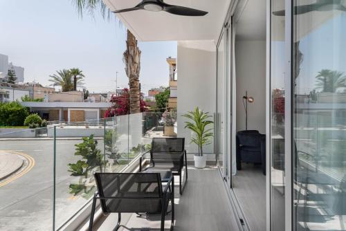 a balcony of a house with chairs and plants at Phaedrus Living Travertine Residences 102 in Strovolos