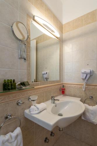 a bathroom with a sink and a mirror at Ostria Hotel  in Adamas