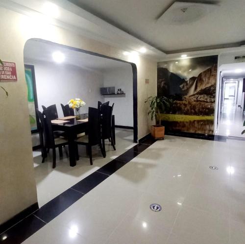a dining room with a table and chairs at Hotel Parkway Inn 58 Street in Bogotá
