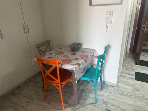 a table with two chairs and a table with a table cloth at Hegla diamant naima in Hergla