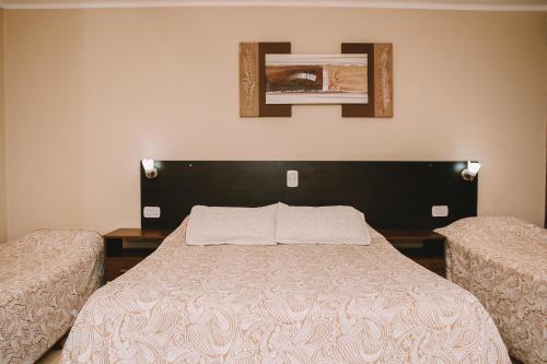 a bedroom with a bed with two twin beds at Altos del Iguazu in Puerto Iguazú