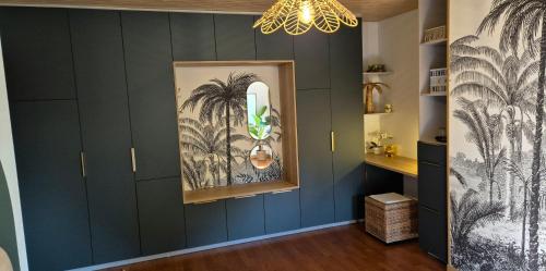 a hallway with navy blue walls and a chandelier at A la Jolie Campagne - chambre et table d'hôtes in Lorigné