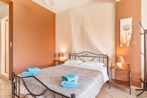 a bedroom with a bed with two towels on it at Christianna studios in Nikiana