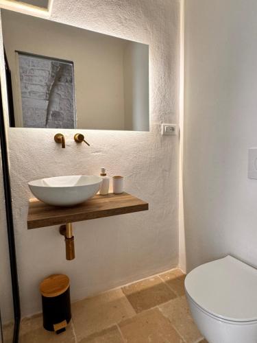 a bathroom with a sink and a toilet at Bianca Ostuni in Ostuni