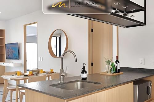 a kitchen with a sink and a counter top at Soho Morelos in Guadalajara