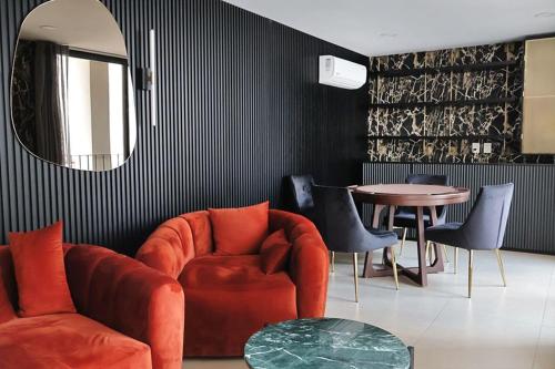 a living room with a red chair and a table at Soho Morelos in Guadalajara