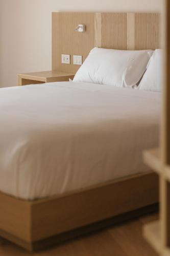 Ένα ή περισσότερα κρεβάτια σε δωμάτιο στο Portonovo Suites