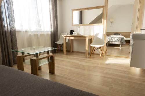 a living room with a table and a mirror at Kresovia in Giby