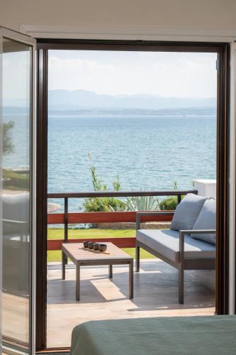 a living room with a view of the ocean at Veya Suite - Private Beach & Pools in Eretria