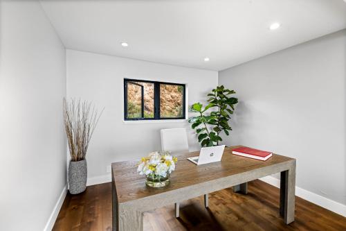 an office with a table with flowers and a laptop at 3920 Red Tail Hawk home in Carmel