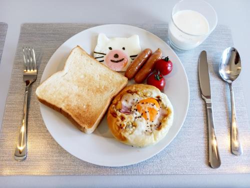 a plate of breakfast food with a pig and toast at ひとふく塩釜 in Shiogama