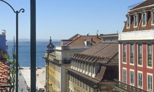 a view of a city with buildings and the water at LV Premier Apartments Baixa- CN in Lisbon