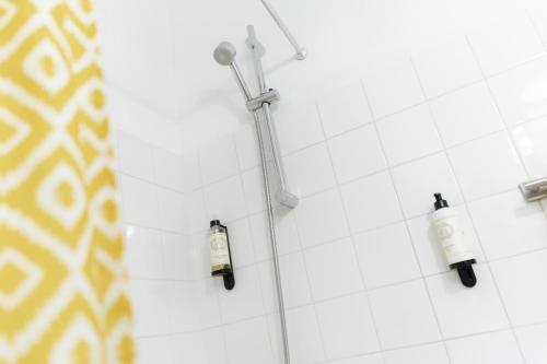 a shower with two shampoo bottles on the wall at LV Premier Apartments Baixa- CN in Lisbon