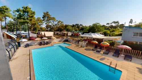 une vue aérienne d'une piscine dans un complexe hôtelier dans l'établissement Cottage Bleu Vendeen, à Saint-Jean-de-Monts