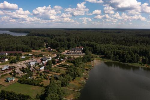 an aerial view of a house next to a lake at Kresovia in Giby