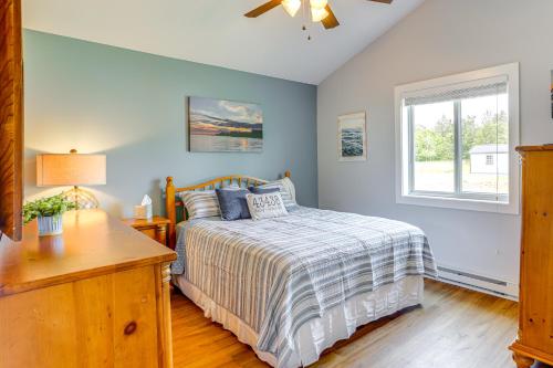 a bedroom with a bed and a window at Walk to Lake Kelleys Island Gem with Deck! in Kelleys Island