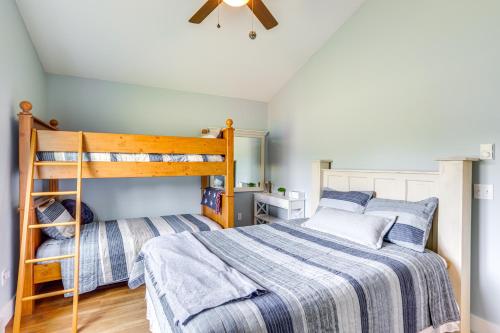 a bedroom with two bunk beds and a ceiling fan at Walk to Lake Kelleys Island Gem with Deck! in Kelleys Island