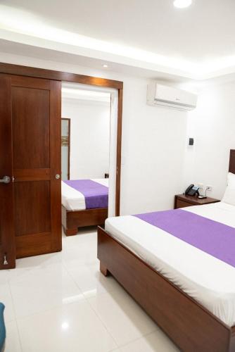 Postel nebo postele na pokoji v ubytování Cataleya Hotel