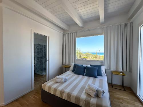 a bedroom with a large bed with a large window at tulip 59 in Gallipoli