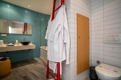 a bathroom with a toilet and a sink at Med-Inn Hotel in Gulluk