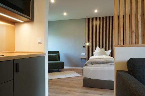 a hotel room with a bed and a couch at Panorama Apart Fichtelberg in Fichtelberg
