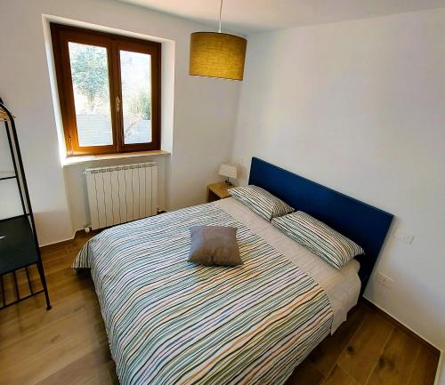 a bedroom with a bed with a pillow on it at Dama35 - Tuscany holiday house - Casentino-La Verna in La Verna