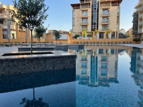 a pool of water in front of some buildings at Hotel Plamena Palace in Primorsko