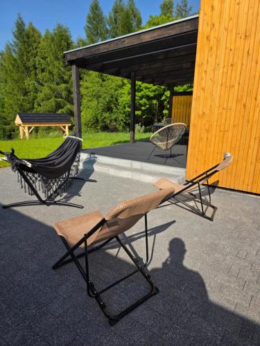 a couple of chairs sitting on a patio at Polana Jelenia Głowa in Wambierzyce