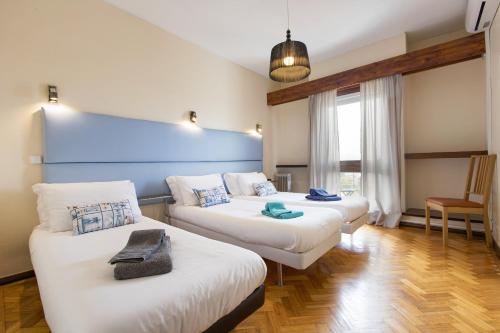 a room with two beds and a blue wall at LV Premier Apartments Clerigos- RE1 in Porto