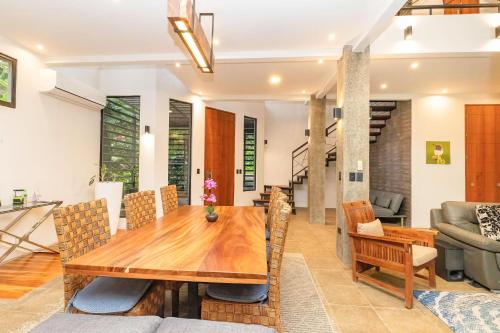 a dining room with a wooden table and chairs at Casa de Agua, A Jungle Retreat in Manuel Antonio in Manuel Antonio
