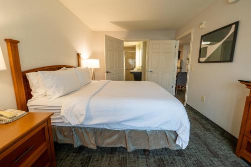 a bedroom with a large white bed and a desk at Staybridge Suites Houston West - Energy Corridor by IHG in Houston