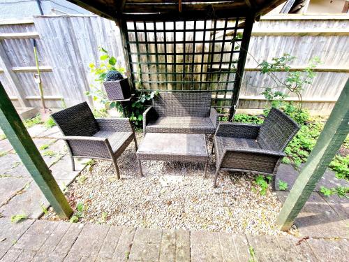 a group of chairs sitting in a gazebo at Sweet Rose Guest House Room 2 in Oxford