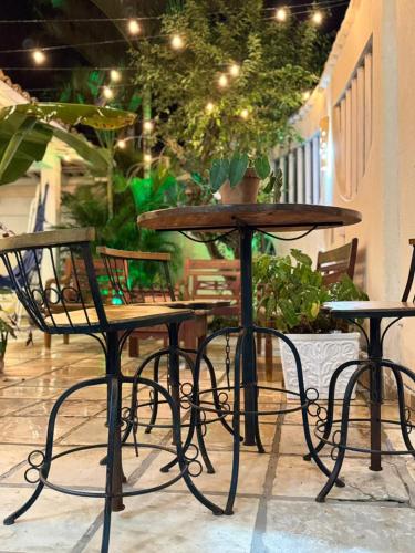 two chairs and a table and two tables and chairs at Pousada Maresia Búzios in Búzios
