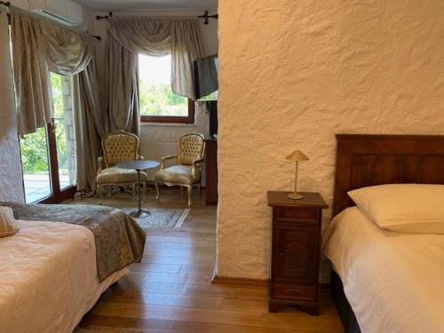 a bedroom with two beds and a table and chairs at Villa Castello Rausch in Poreč