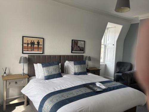 a bedroom with a large bed with a tray on it at The Victoria Inn in Haddington