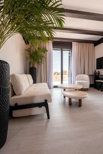 a living room with a couch and a coffee table at Noir Mykonos in Mýkonos City